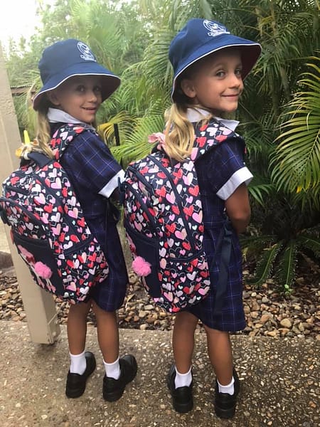 Twins in the same class at school, wearing matching scholl uniforms.
